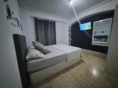 a bedroom with a large bed and a closet at democracia delux in Valencia