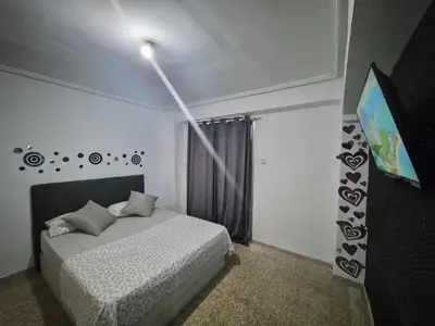 a bedroom with a bed with a tv on the wall at democracia delux in Valencia