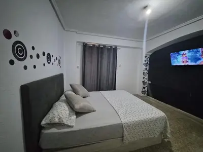 a bedroom with a bed and a flat screen tv at democracia delux in Valencia