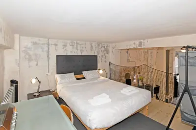 a bedroom with two beds in a room with a wall at GuestReady - Urban Loft in Valencia in Valencia