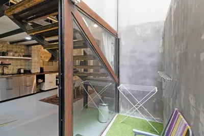 a room with a staircase in a kitchen at GuestReady - Urban Loft in Valencia in Valencia