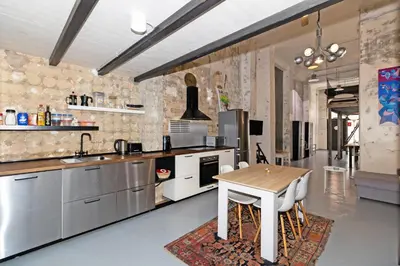 a large kitchen with a wooden table in a room at GuestReady - Urban Loft in Valencia in Valencia