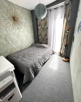 a bedroom with a bed in front of a window at La montaña del sol in Sueca