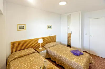 a hotel room with two beds in a room at Florazar 2 Pool & Private Balcony in Cullera
