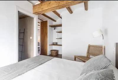 a bedroom with a white bed and a chair at increible ubicación in Valencia