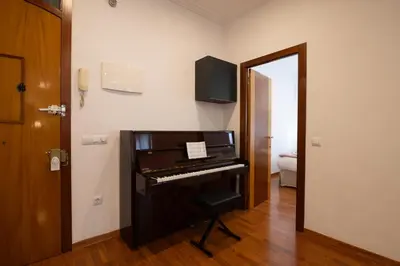 a piano in a room with a door and a mirror at Alojamiento Centrico para 6 Personas in Valencia