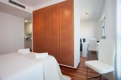 a bedroom with a bed and a wooden wall at SingularStays Oceanic in Valencia
