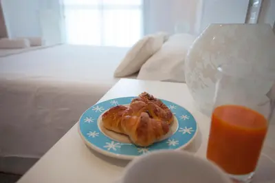 a pastry on a plate on a table with a glass of orange juice at SingularStays Oceanic in Valencia