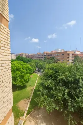 a view of a park with trees and buildings at Apartamento Familiar En Nuevo Centro - Parque Central Turia in Valencia