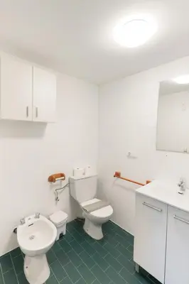 a white bathroom with a toilet and a sink at Apartamento Familiar En Nuevo Centro - Parque Central Turia in Valencia