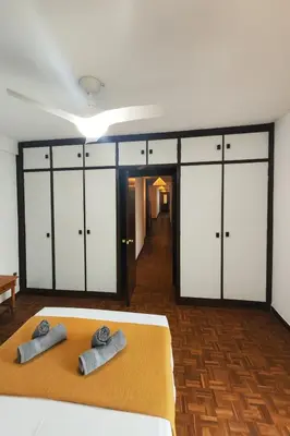 a bedroom with white cabinets and two towels on a bed at Apartamento Familiar En Nuevo Centro - Parque Central Turia in Valencia