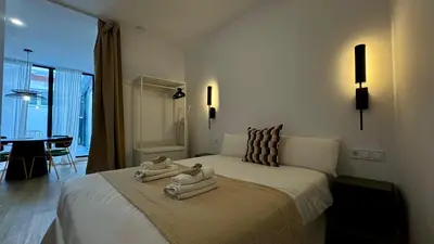 a bedroom with a large bed with towels on it at Boutique Room - Vila Prades in Valencia
