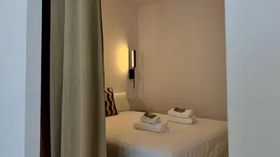 a room with a bed with towels on it at Boutique Room - Vila Prades in Valencia
