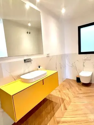 a bathroom with a sink and a mirror and a toilet at Casa Tossal in Valencia