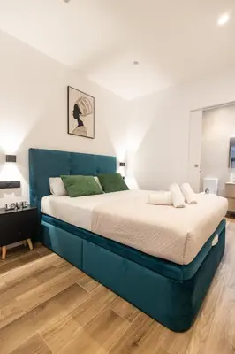 a bedroom with a large bed with a blue headboard at Cielo y Mar in Valencia