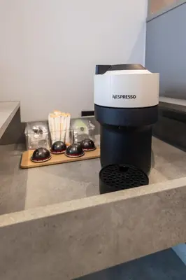 a black and white coffee maker sitting on a counter at Cielo y Mar in Valencia