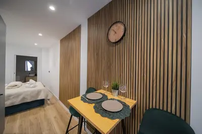 a room with a table and a clock on a wall at Cielo y Mar in Valencia