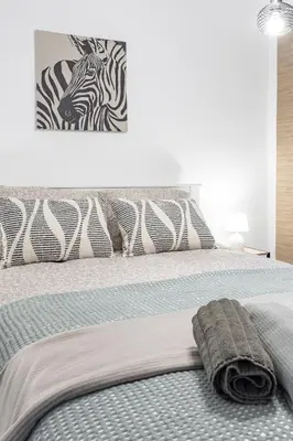 a bedroom with a bed with zebra prints on the wall at Valencia Designer Apartment next to metro in Paterna
