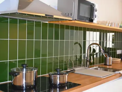 a kitchen counter with pots and pans on a sink at Ruzafa & Oceanografic Suites by Illetes Flats in Valencia