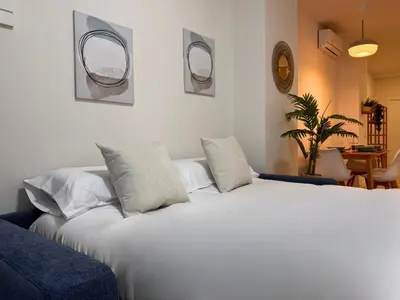 a bedroom with a large white bed with two pillows at Ruzafa & Oceanografic Suites by Illetes Flats in Valencia