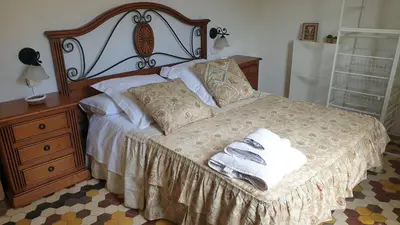 a bedroom with a bed with two towels on it at Adosado acogedor en la Cañada con piscina privada in Partida de La Cañada