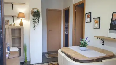 a living room with a table and a couch at Adosado acogedor en la Cañada con piscina privada in Partida de La Cañada