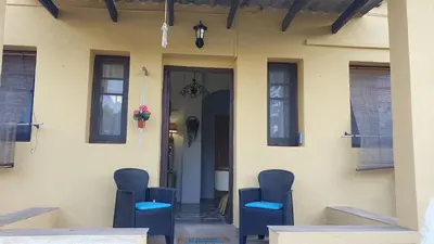 a group of chairs sitting outside of a house at Adosado acogedor en la Cañada con piscina privada in Partida de La Cañada