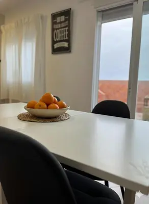 a bowl of oranges sitting on a table at Terraza 120 m2 y paellero - Metro & Aeropuerto in Manises