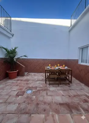 a patio with a table with fruit on it at Terraza 120 m2 y paellero - Metro & Aeropuerto in Manises
