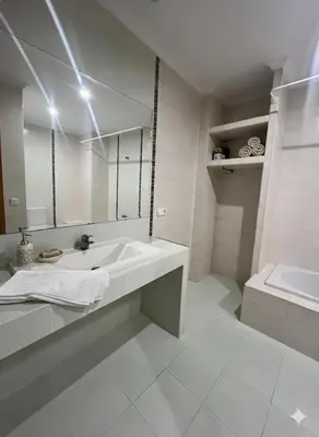 a white bathroom with a sink and a mirror at Terraza 120 m2 y paellero - Metro & Aeropuerto in Manises