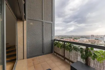 a balcony with a view of a city at Loft Doble Altura con Terraza Panorámica y Piscina in Burjasot