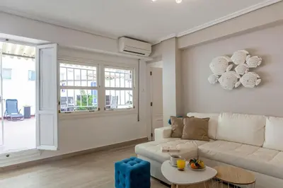 a living room with a white couch and a table at Valencia Flat Rental 3 bedroom in Extramurs in Valencia