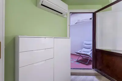a room with a closet with white cabinets and a chair at Valencia Flat Rental 3 bedroom in Extramurs in Valencia