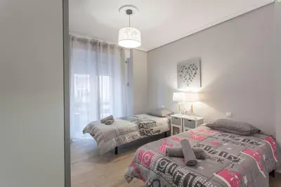 a bedroom with two beds and a window at Valencia Flat Rental 3 bedroom in Extramurs in Valencia