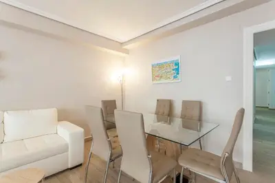 a living room with a glass table and chairs at Valencia Flat Rental 3 bedroom in Extramurs in Valencia