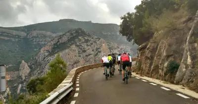 a group of people riding bikes down a road at Cosy Flat Valencia in Masanasa
