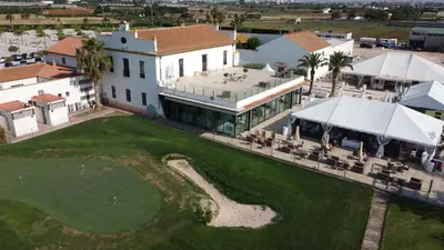 an aerial view of a house with a golf course at Cosy Flat Valencia in Masanasa