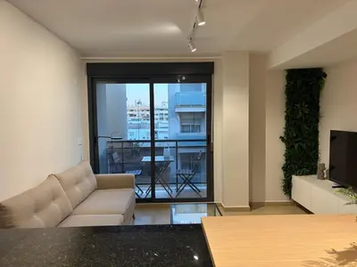a living room with a couch and a balcony at Cosy Flat Valencia in Masanasa
