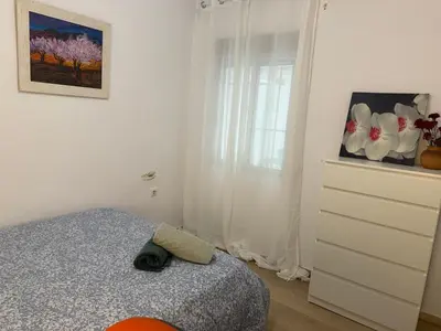 a small bedroom with a bed and a dresser at Precioso piso acerca de Estación Joaquín Sorolla in Valencia