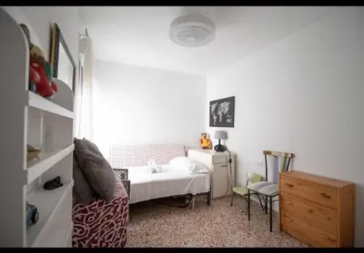 a bedroom with a bed and a desk and a chair at Casa con vistas al rio in Navajas