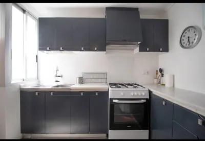 a kitchen with a stove and a clock on the wall at Casa con vistas al rio in Navajas