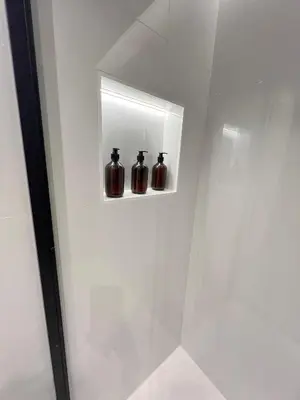three glass jars sitting on a shelf in a shower at Alameda Stay - Apartamento lujoso Ciudad de las Artes y las Ciencias in Valencia