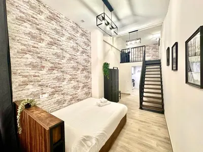 a room with a bed and a brick wall at Ciudades de España in Valencia