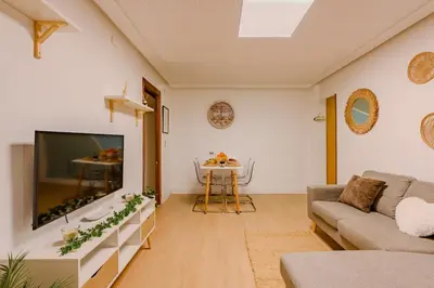 a living room with a large tv and a couch at Cabañal BeachFront , 1 Min to Sea , AC , Coffee , Balcony , FastWifi in Valencia