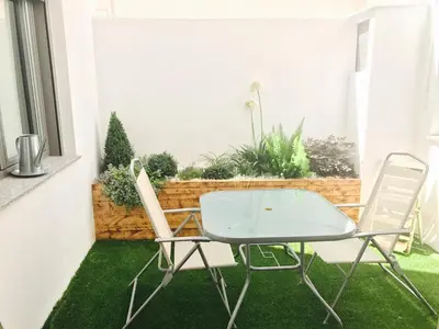 a table and chairs on a patio with grass at Cuco in Requena