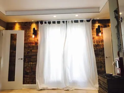 a window with white curtains in a room at Cuco in Requena