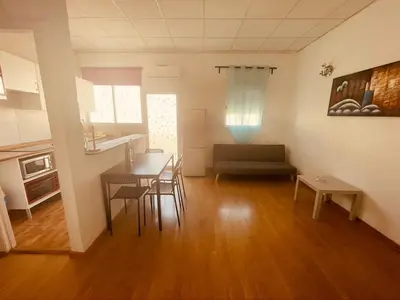 a living room with a table and chairs and a couch at Padre Antonio in Valencia