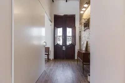 a hallway with a wooden door and a window at House near beach w-terrace in Valencia