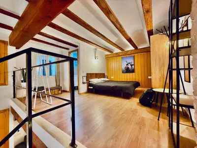 a bedroom with a bed in a room with wooden ceilings at Duplex en el Carmen in Valencia
