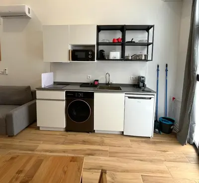 a kitchen with a sink and a washing machine at Urban loft Benicalap in Valencia